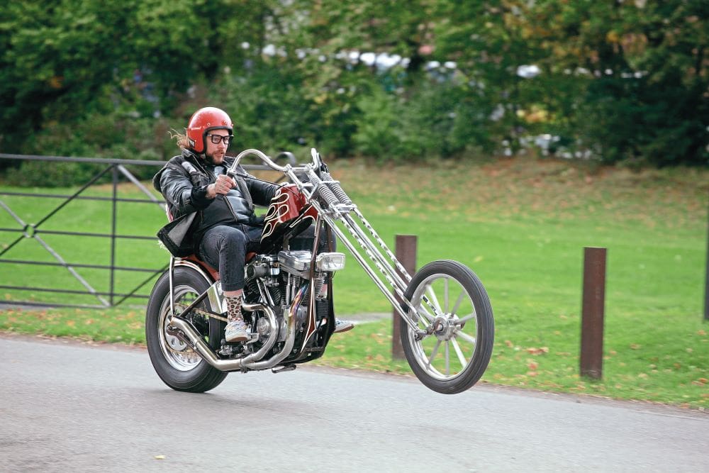 Jason Mellers performs a wheelie on his custom bike.